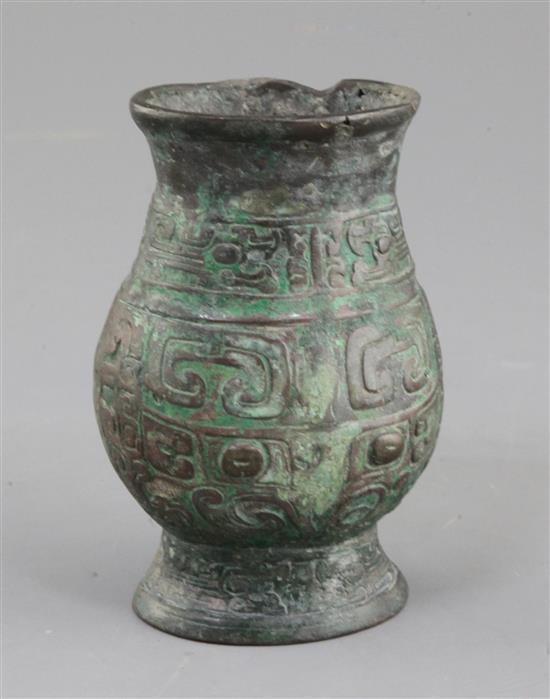 A small Chinese archaic bronze ritual wine cup, Zhi, Western Zhou dynasty, 11th century B.C., 11cm high, hole and rim repairs